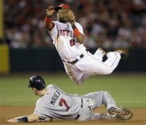 Erick Aybar leaps in the air to complete a double play.jpg