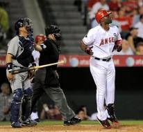 Torii Hunter lets go of his bat as he watches his home run.JPG