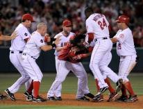Erick Aybar is mobbed by teammates after getting the game winning hit.JPG