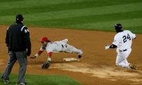 Erick Aybar tries to make a diving stop of an errant throw.JPG