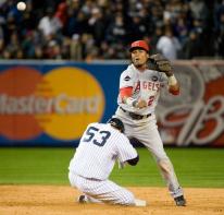 Erick Aybar throws to first as a Yankee tries to break up the double play.JPG