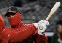 Kendry Morales takes batting practice with face covered in the cold.JPG