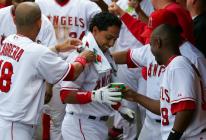 maicer izturis congratulated in dugout.jpg