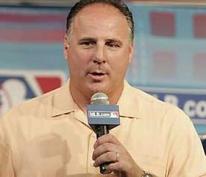 Mike Scioscia holds a microphone.jpg